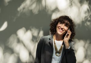 woman smiling while on the phone