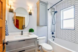 well lit bathroom with oval mirror